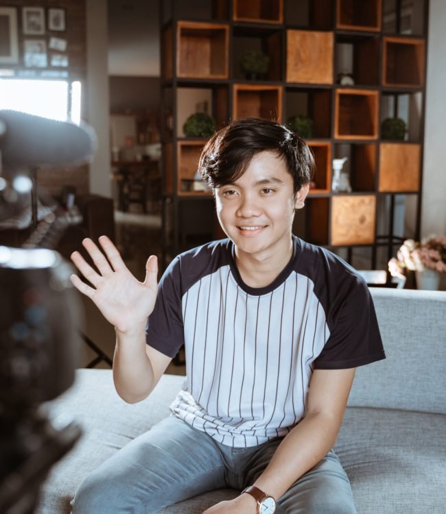 asian young man blogger make review something with recorded using the camera on foreground